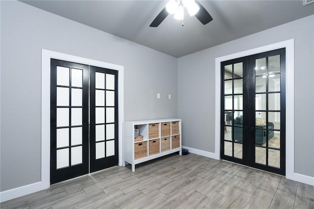 1909 Crump St, Pea Ridge, AR 72751 - unfurnished room with french doors, baseboards, wood finished floors, and a ceiling fan