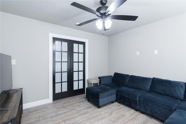 1909 Crump St, Pea Ridge, AR 72751 - living area with french doors, light wood finished floors, ceiling fan, and baseboards