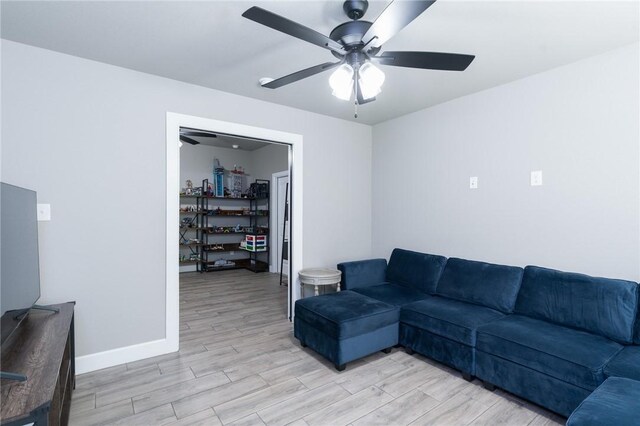 1909 Crump St, Pea Ridge, AR 72751 - living room featuring a ceiling fan, light wood-style floors, and baseboards