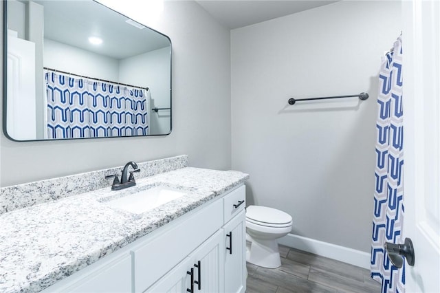 1909 Crump St, Pea Ridge, AR 72751 - full bathroom with vanity, toilet, wood finished floors, and baseboards