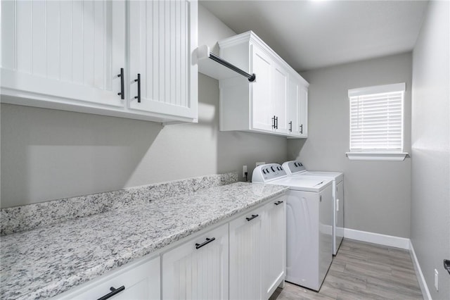 1909 Crump St, Pea Ridge, AR 72751 - laundry room with cabinet space, separate washer and dryer, light wood finished floors, and baseboards
