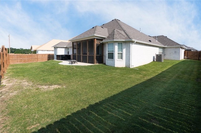 1909 Crump St, Pea Ridge, AR 72751 - rear view of property with central air condition unit, a sunroom, a fire pit, a patio, and roof with shingles