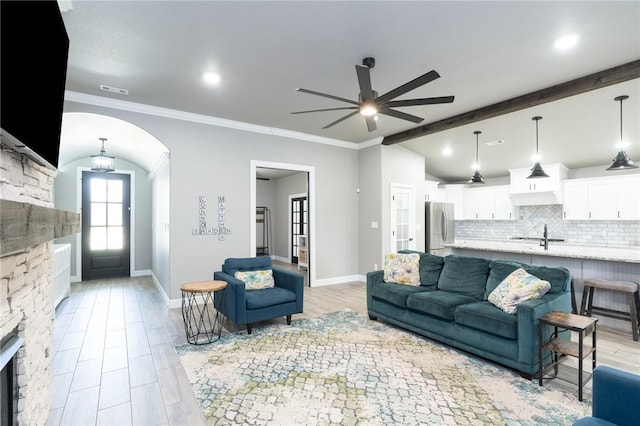 1909 Crump St, Pea Ridge, AR 72751 - living area with ceiling fan, arched walkways, ornamental molding, and baseboards