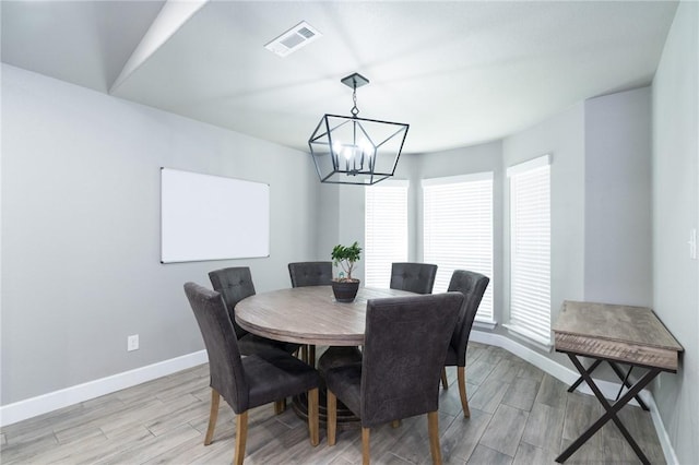 1909 Crump St, Pea Ridge, AR 72751 - dining space featuring a chandelier, baseboards, and light wood-type flooring