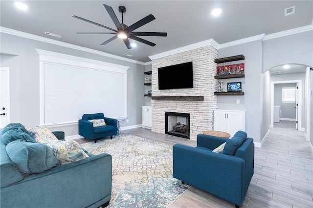 1909 Crump St, Pea Ridge, AR 72751 - living area with ceiling fan, arched walkways, wood finished floors, baseboards, and ornamental molding