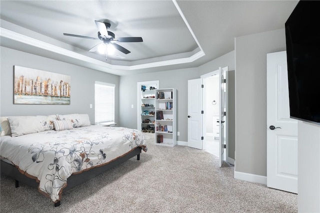 1909 Crump St, Pea Ridge, AR 72751 - bedroom featuring a tray ceiling, light carpet, ceiling fan, and baseboards
