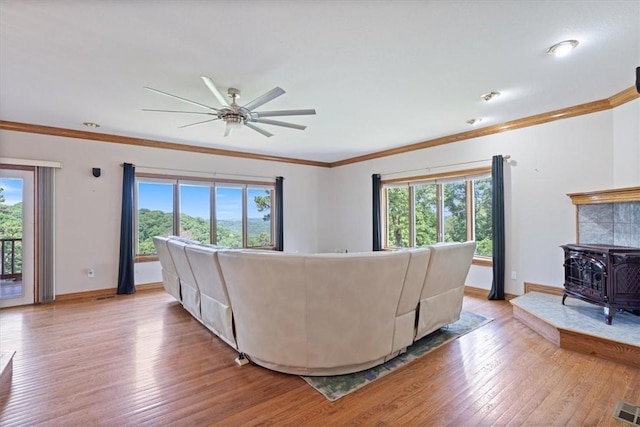 5 Augusta Ln, Holiday Island, AR 72631 - living room with plenty of natural light, light wood finished floors, crown molding, ceiling fan, and a wood stove
