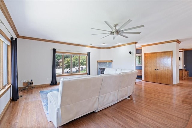5 Augusta Ln, Holiday Island, AR 72631 - living area featuring light wood-style floors, crown molding, ceiling fan, baseboards, and a fireplace