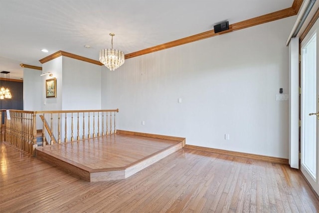 5 Augusta Ln, Holiday Island, AR 72631 - empty room featuring a chandelier, ornamental molding, wood finished floors, and baseboards