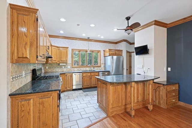 5 Augusta Ln, Holiday Island, AR 72631 - kitchen featuring stainless steel appliances, a sink, ornamental molding, backsplash, and brown cabinets