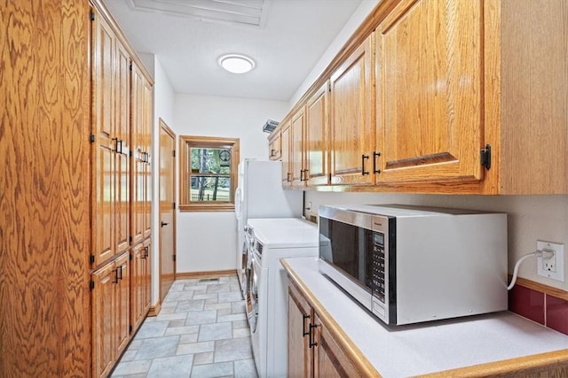 5 Augusta Ln, Holiday Island, AR 72631 - washroom with washing machine and clothes dryer, stone finish flooring, cabinet space, and baseboards