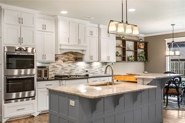 700 SE Yale St, Bentonville, AR 72712 - kitchen featuring stainless steel appliances, open shelves, dark wood-type flooring, decorative backsplash, and white cabinetry