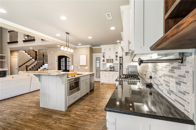 700 SE Yale St, Bentonville, AR 72712 - kitchen with ornamental molding, appliances with stainless steel finishes, decorative backsplash, recessed lighting, and dark wood finished floors