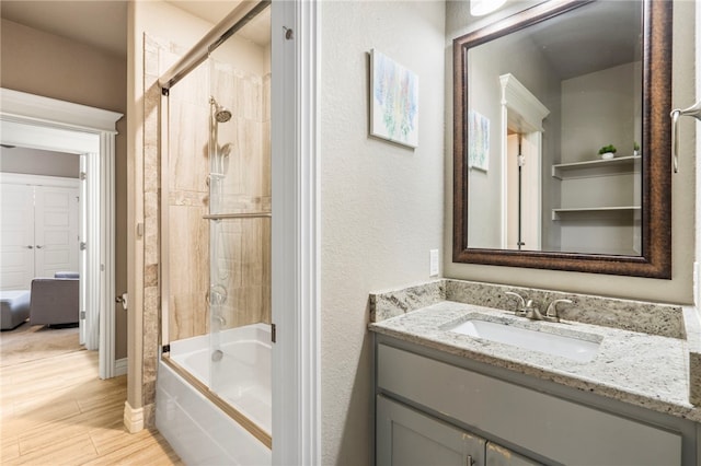 700 SE Yale St, Bentonville, AR 72712 - full bath featuring vanity, shower / bath combination, and wood finished floors
