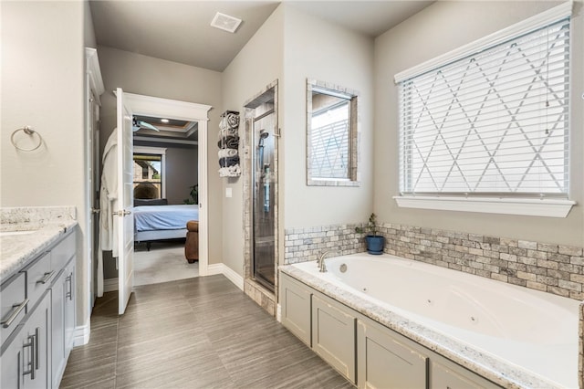 700 SE Yale St, Bentonville, AR 72712 - bathroom with ensuite bathroom, a stall shower, a whirlpool tub, and vanity