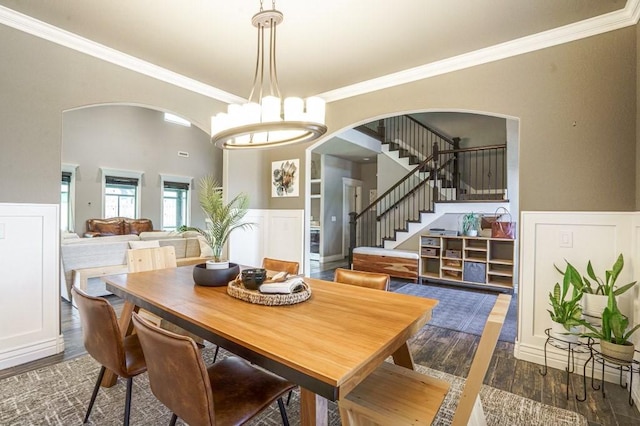700 SE Yale St, Bentonville, AR 72712 - dining room with crown molding, stairs, wood finished floors, arched walkways, and wainscoting
