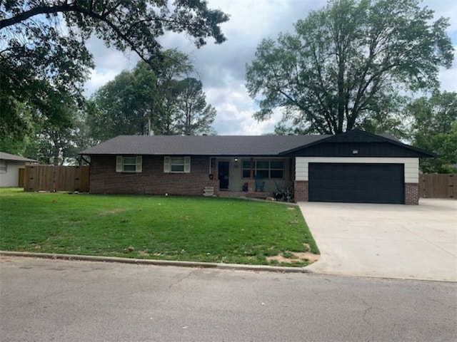 712 Carlton St, Springdale, AR 72762 - ranch-style house featuring an attached garage, brick siding, and concrete driveway
