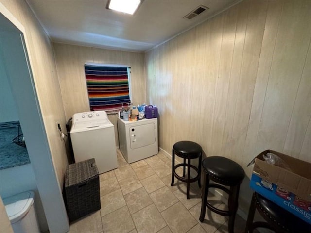 712 Carlton St, Springdale, AR 72762 - laundry room featuring separate washer and dryer, wood walls, and crown molding