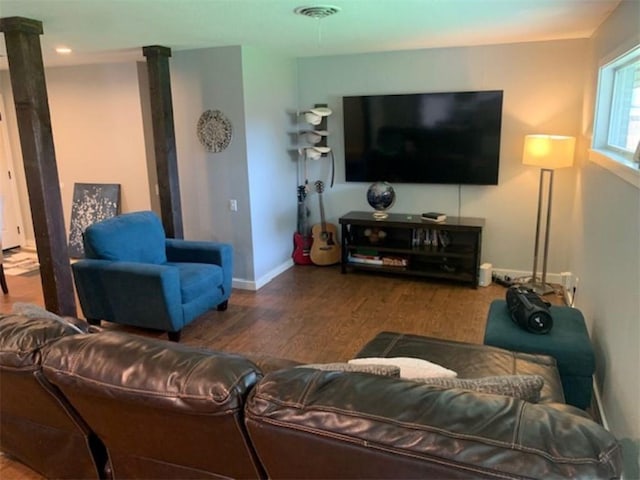 712 Carlton St, Springdale, AR 72762 - living room featuring wood finished floors, baseboards, and decorative columns