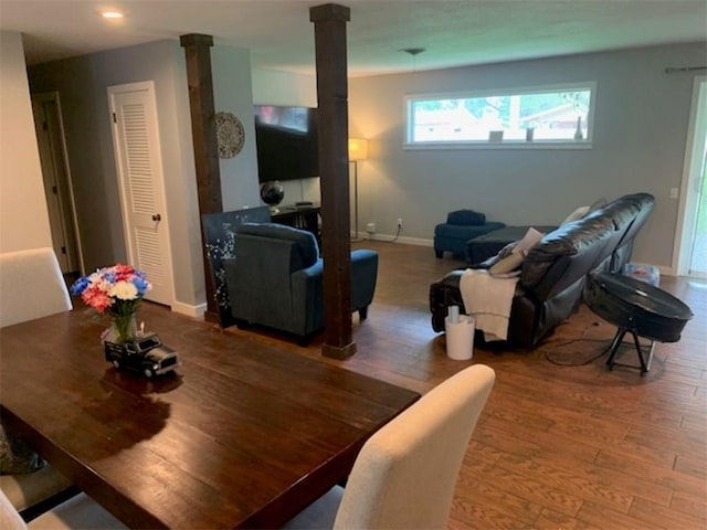 712 Carlton St, Springdale, AR 72762 - dining room with ornate columns, wood finished floors, and baseboards