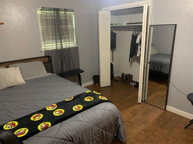 712 Carlton St, Springdale, AR 72762 - bedroom featuring wood finished floors, a closet, and baseboards