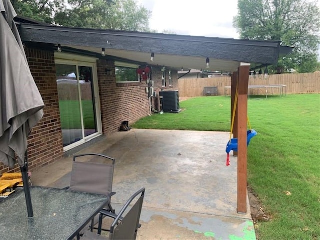 712 Carlton St, Springdale, AR 72762 - view of patio featuring central AC unit and a trampoline
