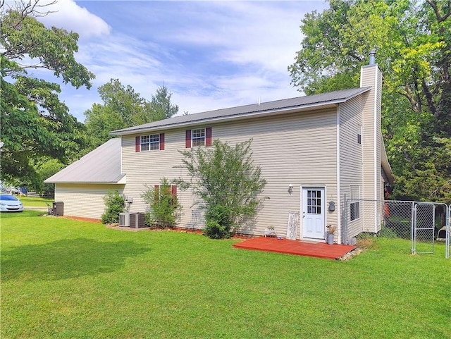 9225 Charles St, Rogers, AR 72756 - back of house with a chimney, a metal roof, and a deck