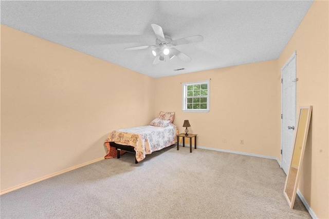 9225 Charles St, Rogers, AR 72756 - bedroom featuring light carpet, a ceiling fan, and a textured ceiling