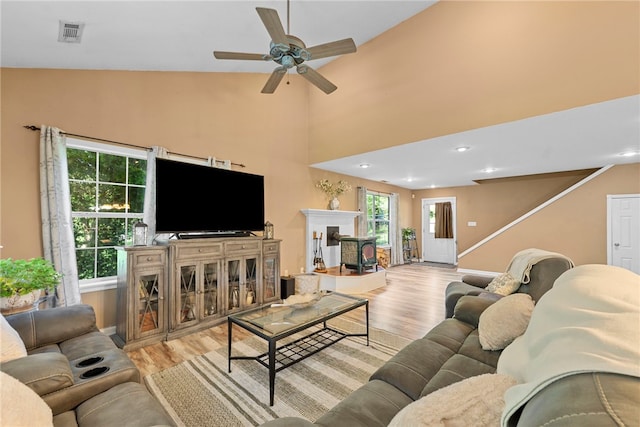 9225 Charles St, Rogers, AR 72756 - living area featuring wood finished floors, ceiling fan, a fireplace, and vaulted ceiling