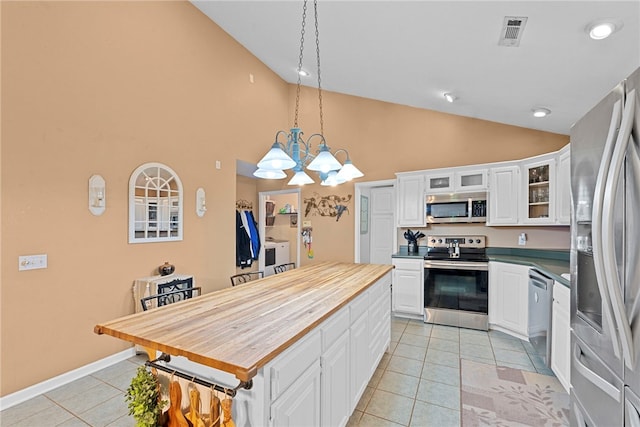 9225 Charles St, Rogers, AR 72756 - kitchen featuring stainless steel appliances, light tile patterned floors, butcher block counters, a kitchen island, and a chandelier
