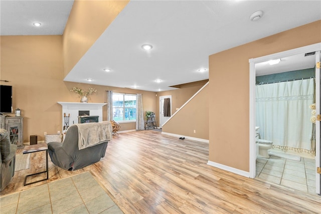 9225 Charles St, Rogers, AR 72756 - living area featuring a fireplace, wood finished floors, recessed lighting, and stairs