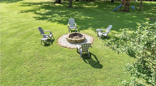 9225 Charles St, Rogers, AR 72756 - view of green lawn featuring a fire pit and a playground