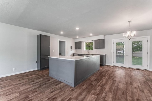 263 Van Dorn St, Pea Ridge, AR 72751 - kitchen featuring gray cabinets, dark wood-style flooring, baseboards, a chandelier, and french doors
