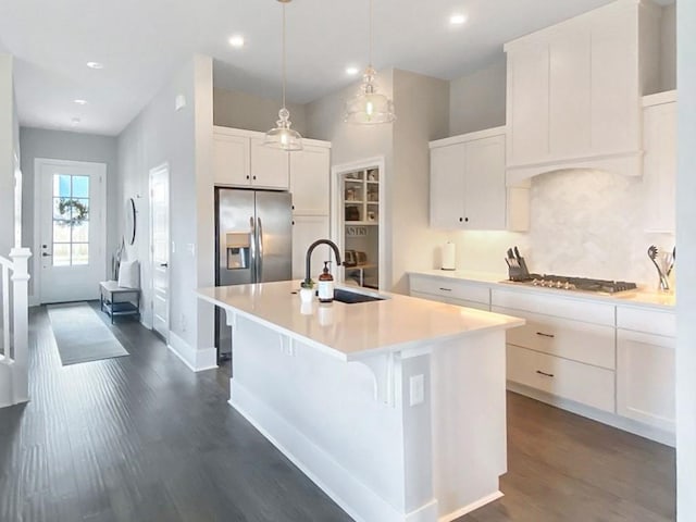 1432 Cannon Ln, Cave Springs, AR 72718 - kitchen with appliances with stainless steel finishes, dark wood-style flooring, a center island with sink, light countertops, and white cabinetry