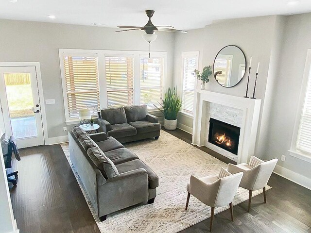 1432 Cannon Ln, Cave Springs, AR 72718 - living room with ceiling fan, dark wood finished floors, plenty of natural light, a warm lit fireplace, and recessed lighting