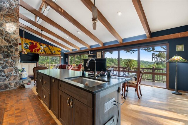 7 El Dorado Dr, Holiday Island, AR 72631 - kitchen with a sink, dark countertops, a kitchen island with sink, open floor plan, and plenty of natural light