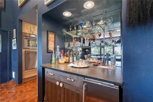 7 El Dorado Dr, Holiday Island, AR 72631 - indoor bar with wine cooler, brick patterned floors, appliances with stainless steel finishes, and a textured wall