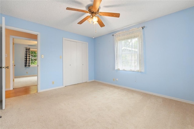 24 Meadow Lark Ln, Harrison, AR 72601 - unfurnished bedroom with carpet flooring, a closet, multiple windows, baseboards, and a textured ceiling