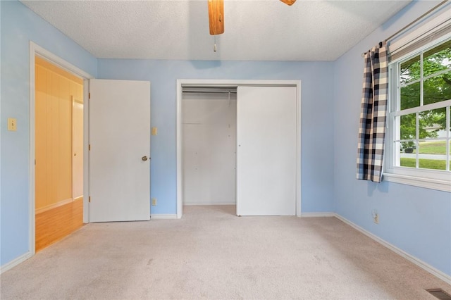 24 Meadow Lark Ln, Harrison, AR 72601 - unfurnished bedroom featuring carpet flooring, a textured ceiling, a closet, baseboards, and a ceiling fan