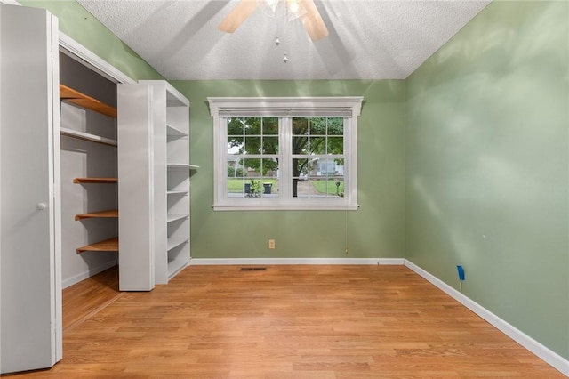24 Meadow Lark Ln, Harrison, AR 72601 - unfurnished bedroom with light wood-style floors, baseboards, a textured ceiling, and a ceiling fan