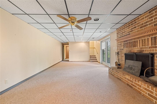 24 Meadow Lark Ln, Harrison, AR 72601 - unfurnished living room with carpet floors, a ceiling fan, a brick fireplace, a drop ceiling, and stairs