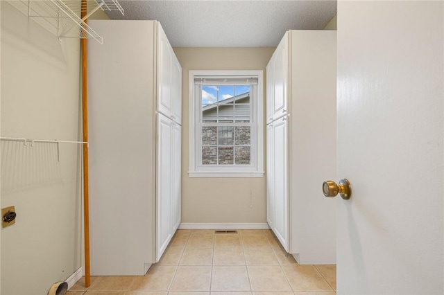 24 Meadow Lark Ln, Harrison, AR 72601 - laundry area with electric dryer hookup, light tile patterned flooring, and baseboards