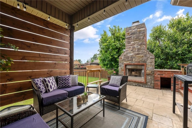 2314 S Mont Blanc Ave, Rogers, AR 72758 - view of patio with an outdoor living space with a fireplace
