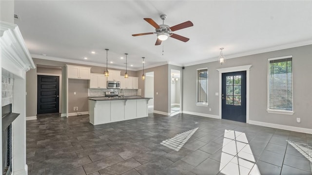 694 Bison Run St, Farmington, AR 72730 - kitchen with stainless steel microwave, open floor plan, dark countertops, ceiling fan, and baseboards