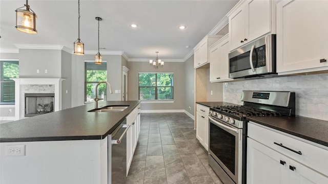 694 Bison Run St, Farmington, AR 72730 - kitchen with appliances with stainless steel finishes, dark countertops, a sink, decorative backsplash, and ornamental molding