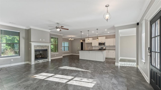 694 Bison Run St, Farmington, AR 72730 - unfurnished living room featuring ceiling fan, baseboards, ornamental molding, a sink, and a fireplace