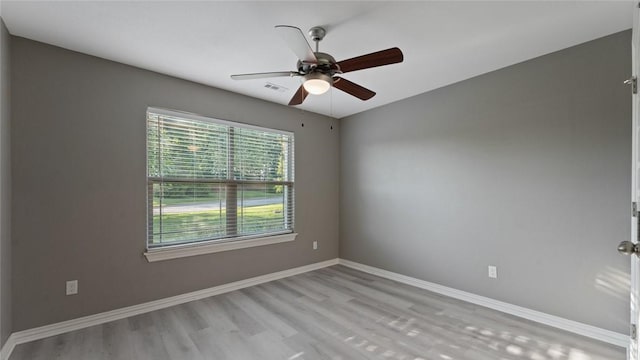 694 Bison Run St, Farmington, AR 72730 - spare room with light wood-style flooring, a ceiling fan, and baseboards