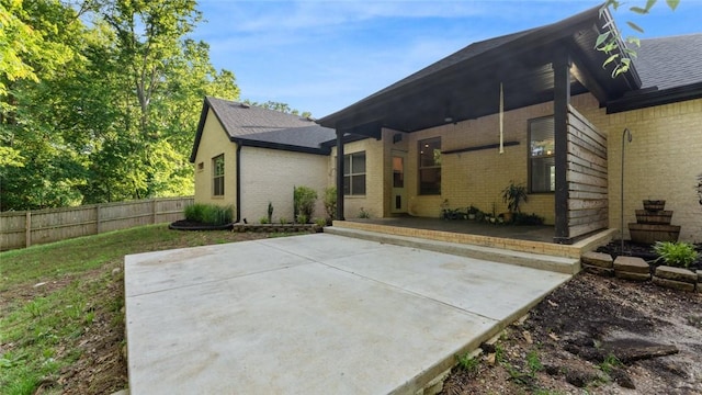 694 Bison Run St, Farmington, AR 72730 - back of house with brick siding, a patio, and roof with shingles