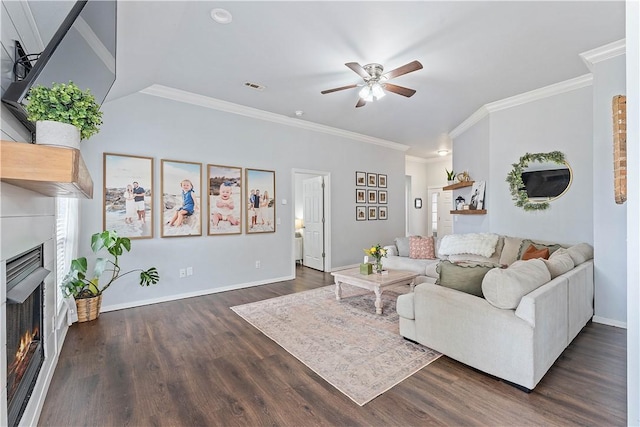 1031 Charles St, Pea Ridge, AR 72751 - living area with ceiling fan, a warm lit fireplace, crown molding, dark wood-style flooring, and baseboards