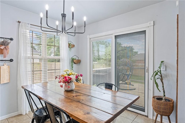 1031 Charles St, Pea Ridge, AR 72751 - dining area featuring light tile patterned floors, a chandelier, and baseboards